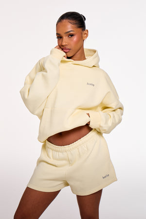 Kaiia Chrome Logo Mini Shorts Lemon