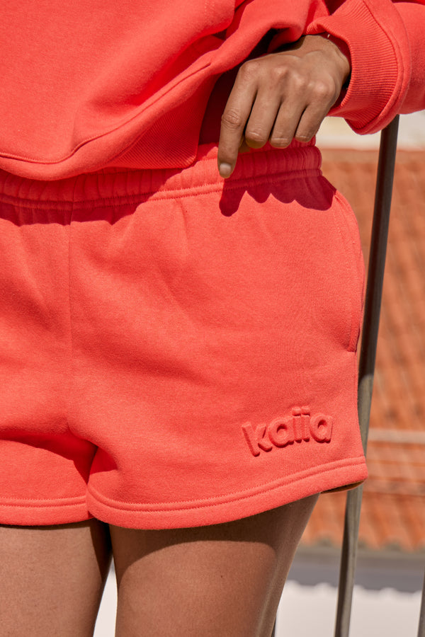 Kaiia Embossed Logo Mini Sweat Shorts Bright Coral